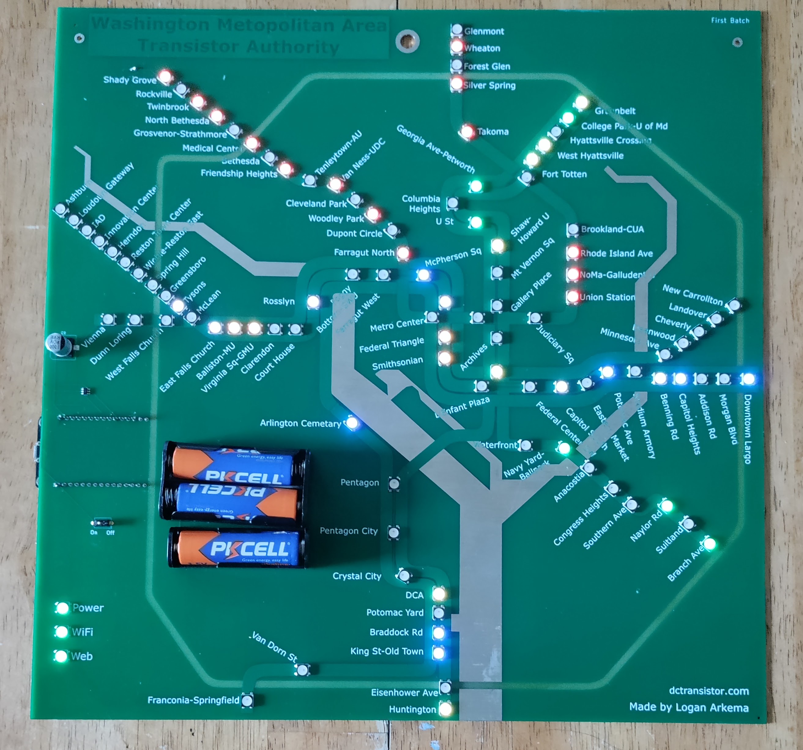 Picture of a DCTransistor board displaying live train positions. The battery holder on the bottom-left of the board holds 3 AA batteries.